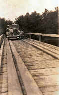 The old bridge at the narrows between Planting
                Ground and Long Lake. It was built to reach Whispering
                Pines. to